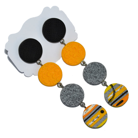 Μακριά σκουλαρίκια με τέσσερις διαφορετικούς κύκλους σε μαύρο κίτρινο και γκρι