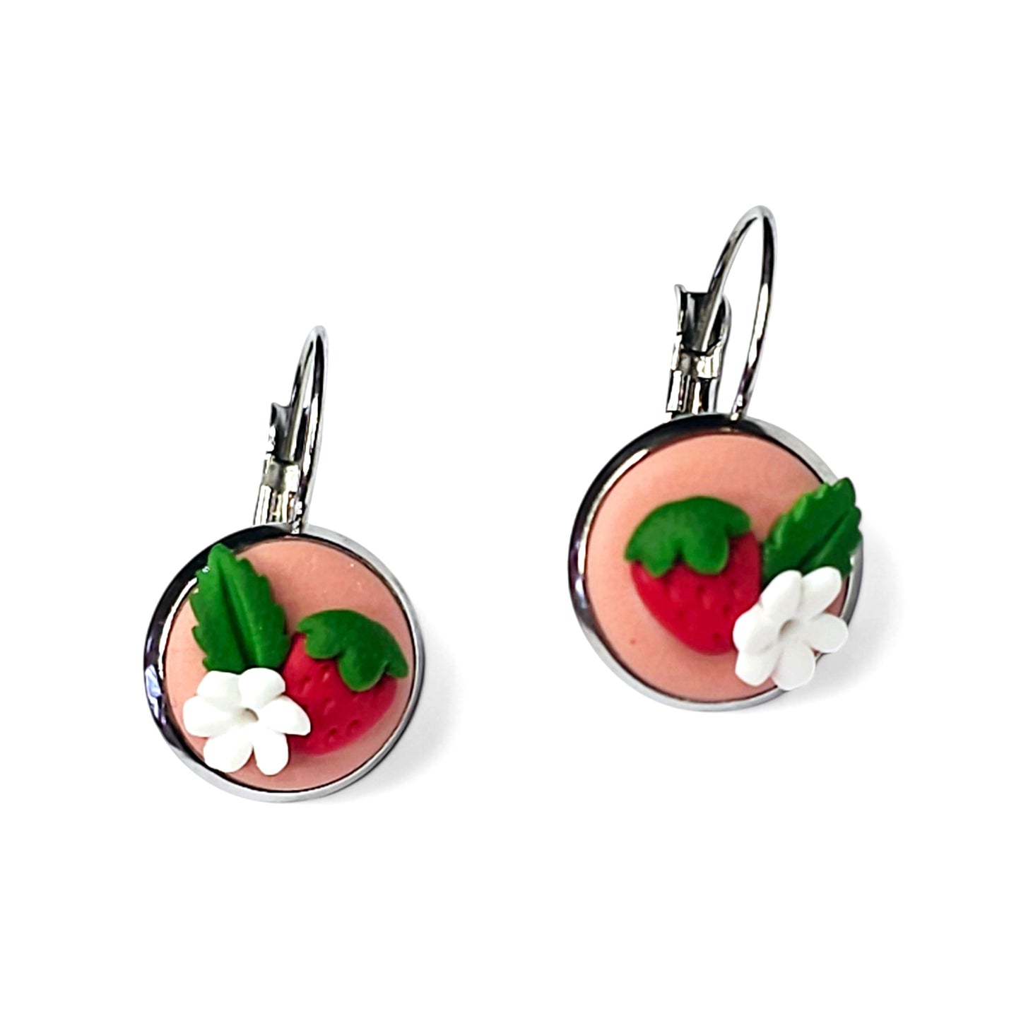 Μικρά κρεμαστά στρογγυλά σκουλαρίκια κόκκινες φραουλίτσες σε απαλό ροζ φόντο από πολυμερικό πηλό