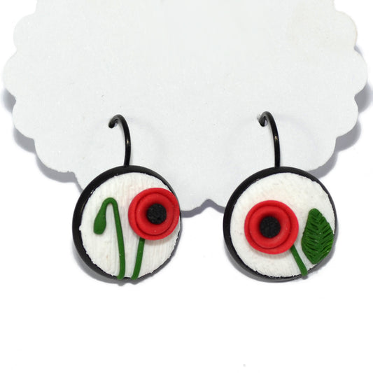 Ατσάλινα σκουλαρίκια λίγο κρεμαστά με ανάγλυφες παπαρούνες από πηλό